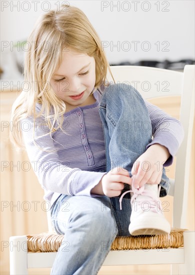 Close up of girl tying shoe. Date : 2008