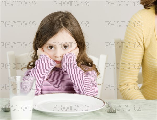 Girl sitting at dinner table. Date : 2008