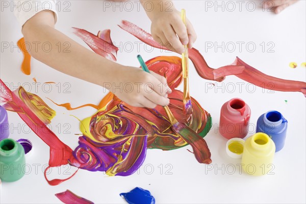 Children painting on table. Date : 2008