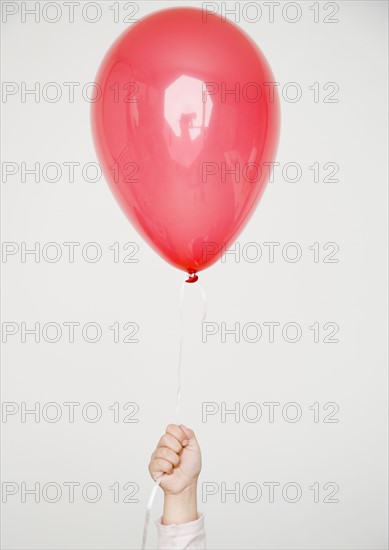 Child holding red balloon. Date : 2008