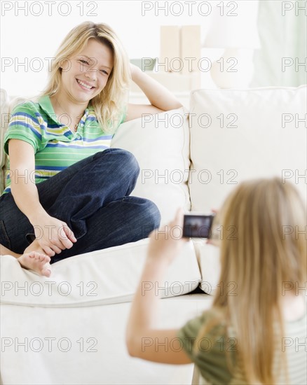 Girl taking photograph of mother. Date : 2008