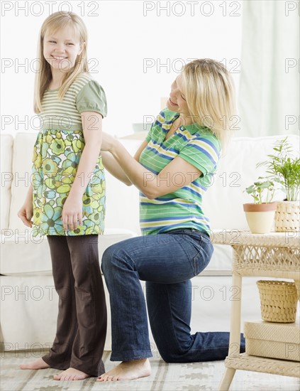 Mother adjusting daughter’s shirt. Date : 2008