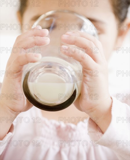 Hispanic girl drinking glass of milk. Date : 2008