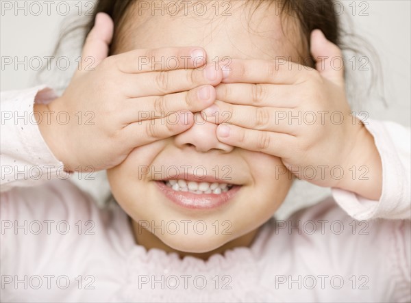 Hispanic girl covering eyes. Date : 2008