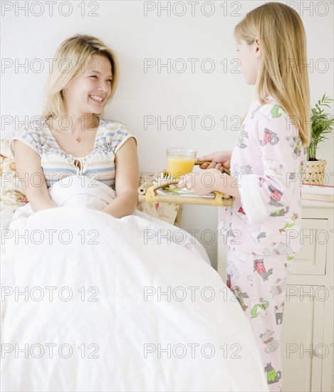 Daughter bringing mother breakfast in bed. Date : 2008