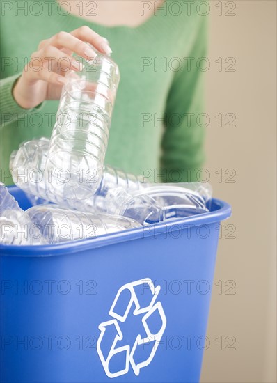 Woman filling recycling bin. Date : 2008