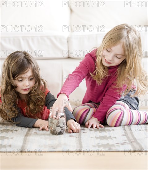 Sisters counting coins. Date : 2008
