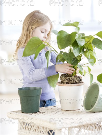Girl repotting plant. Date : 2008