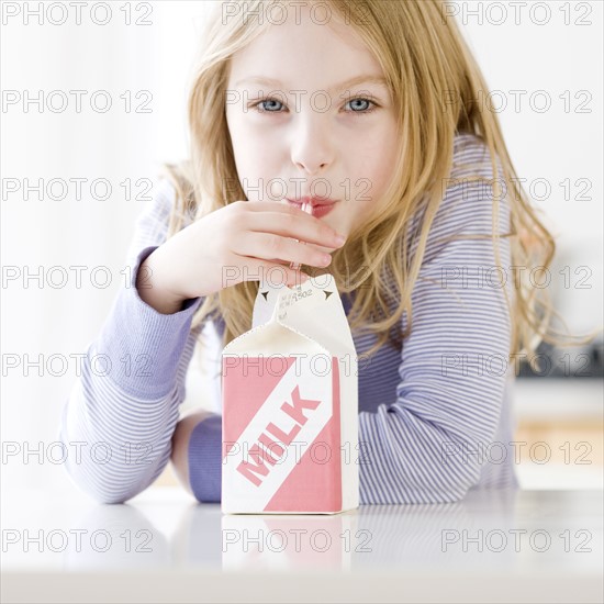 Girl drinking carton of milk. Date : 2008