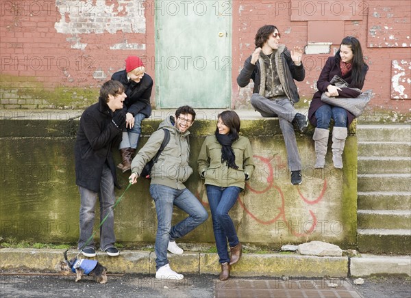 Group of friends sitting in urban scene. Date : 2008