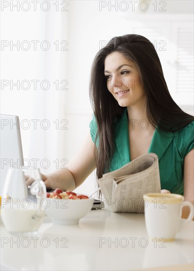 Woman looking at laptop in morning. Date : 2008