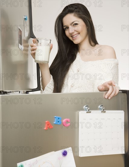 Woman holding glass of milk. Date : 2008