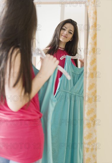 Woman looking at dress in mirror. Date : 2008