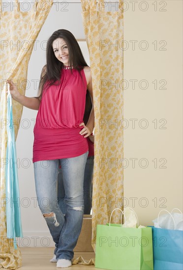 Woman standing in fitting room doorway. Date : 2008