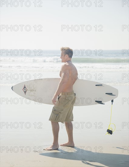 Man holding surfboard. Date : 2008