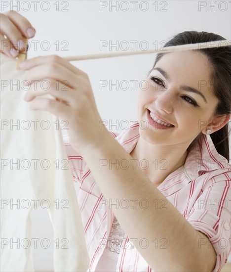 Woman hanging laundry on clothes line. Date : 2008