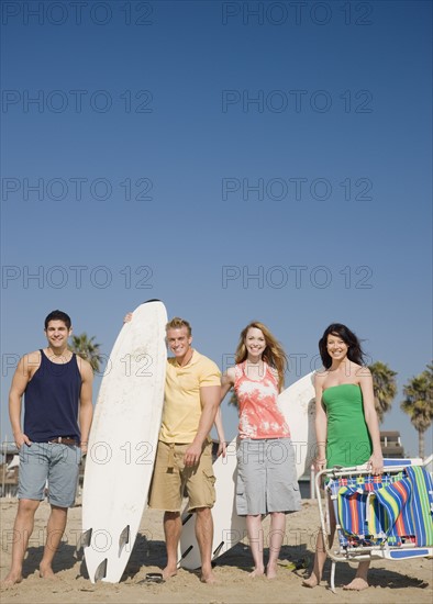 Group of friends standing on beach. Date : 2008