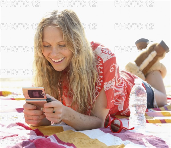 Woman dialing cell phone. Date : 2008