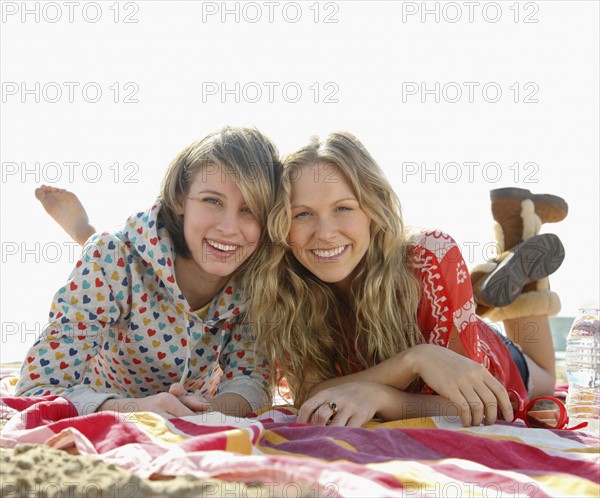 Two young women laying on beach. Date : 2008