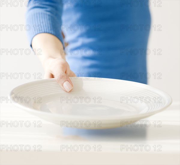 Woman holding empty dish. Date : 2008