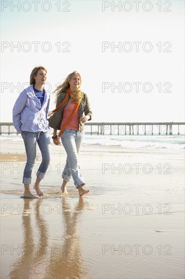 Two women walking on beach. Date : 2008