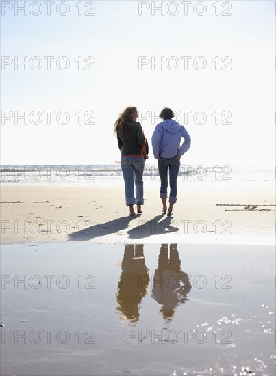 Two women walking on beach. Date : 2008