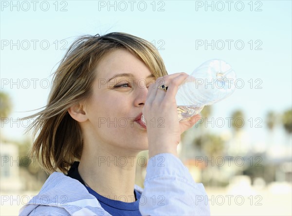 Woman drinking water bottle. Date : 2008