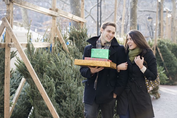 Couple shopping for Christmas trees. Date : 2008