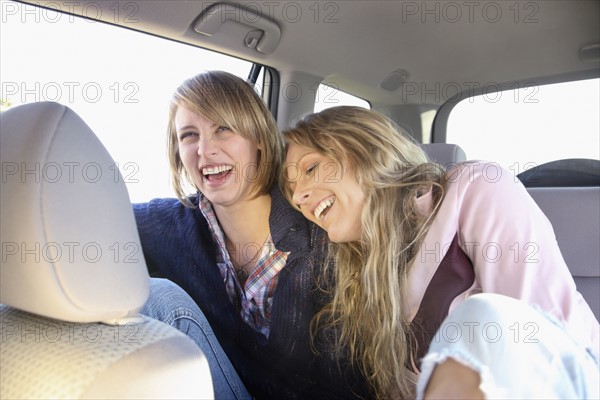 Two women in backseat of car. Date : 2008