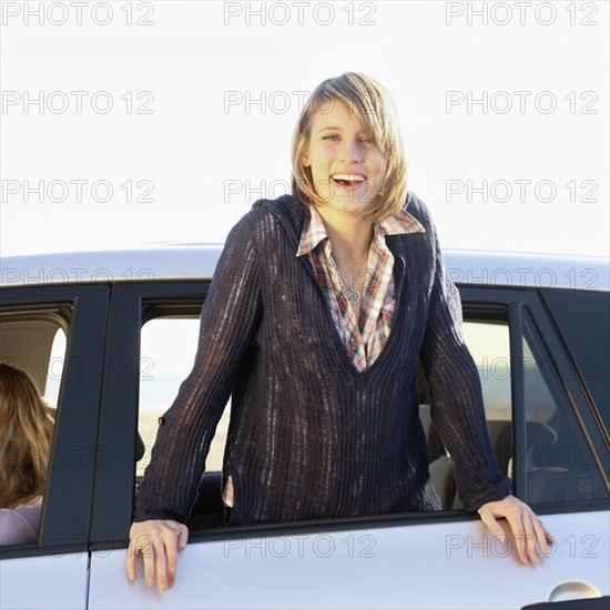 Woman leaning out of car window. Date : 2008