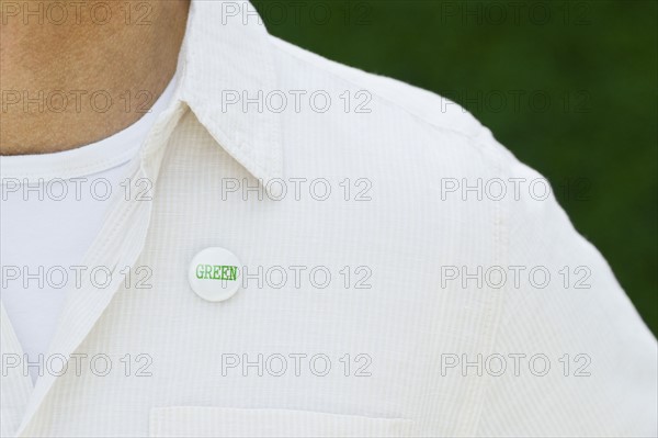 Eco-friendly button on man’s shirt.