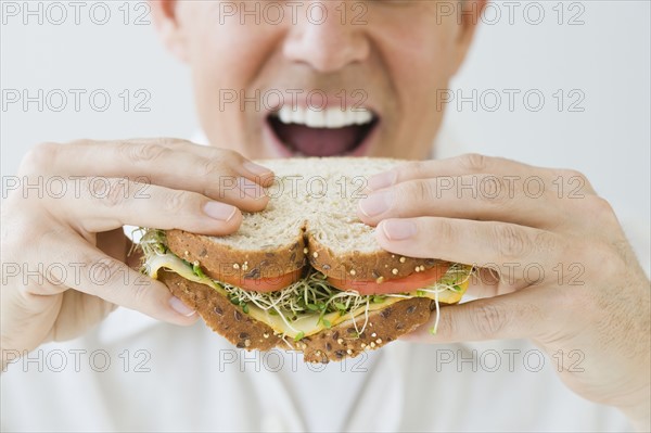 Man eating sandwich.