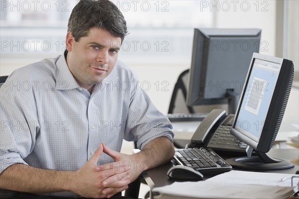 Businessman sitting at desk.