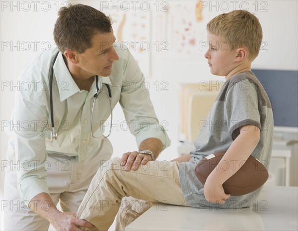 Male doctor examining boy.