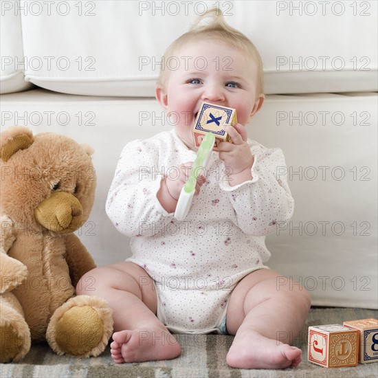 Baby playing with alphabet blocks. Date : 2008