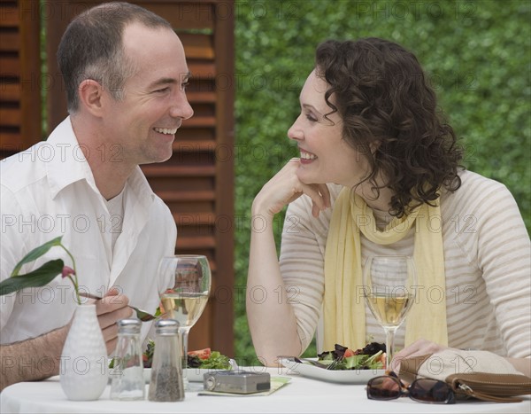 Couple eating outdoors.