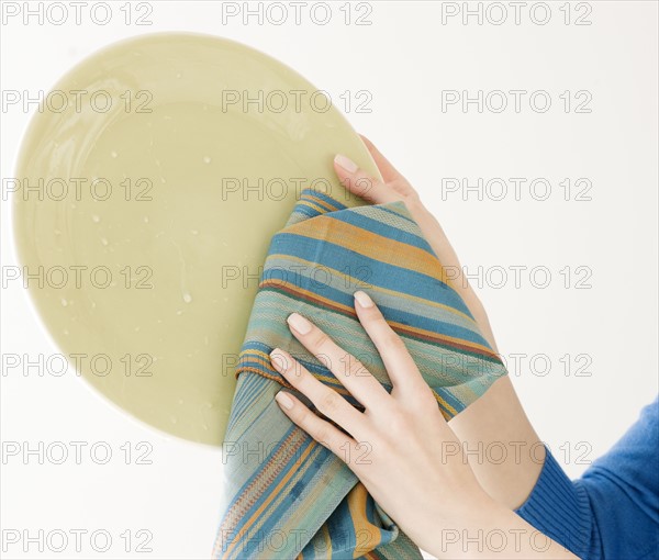 Woman drying dish. Date : 2008
