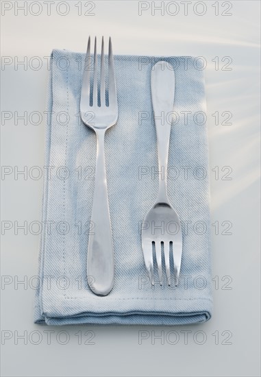 Close up of forks on napkin.