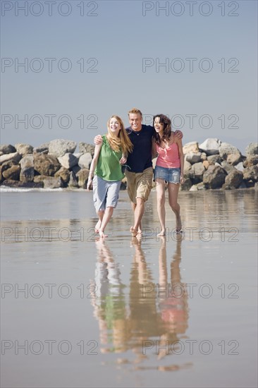 Friends walking on beach. Date : 2008