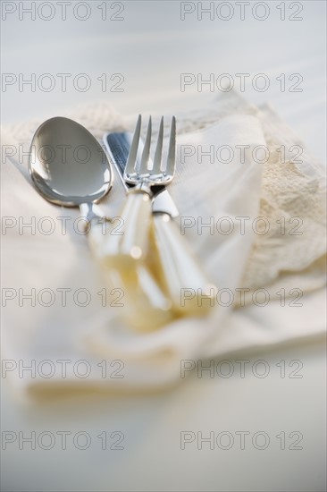 Close up of silverware on napkin.