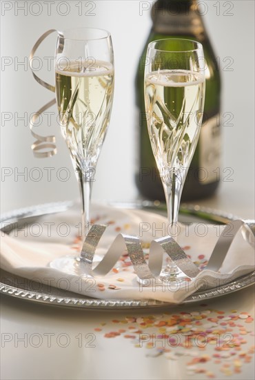 Glasses of champagne on tray.