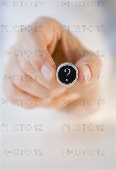 Man holding question mark .