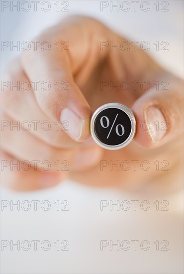 Man holding percent symbol .