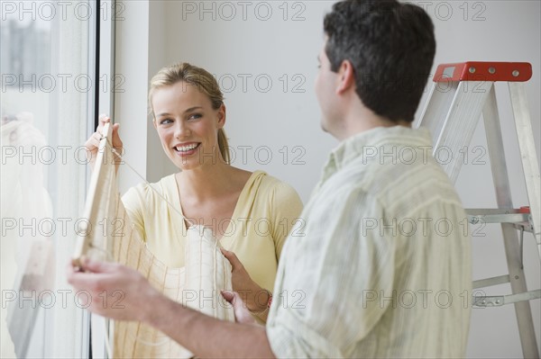 Couple hanging window blinds.