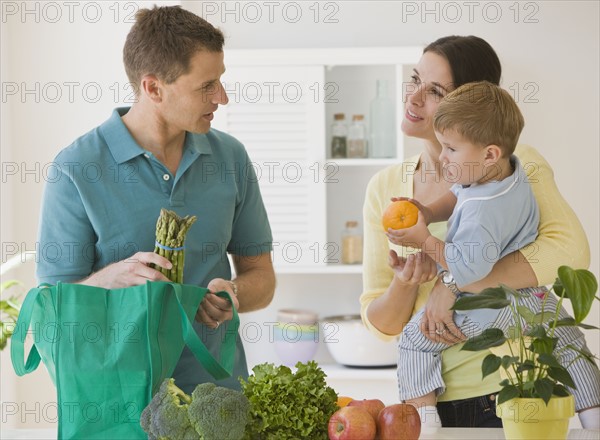 Family unpacking groceries.