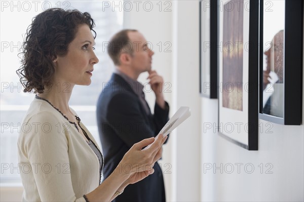 Couple looking at art in art gallery.