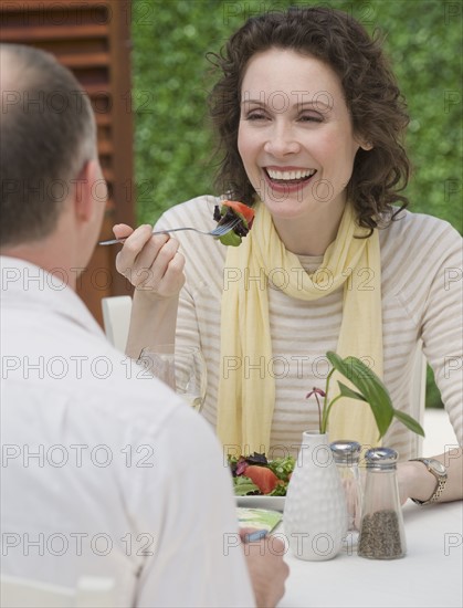 Couple eating outdoors.