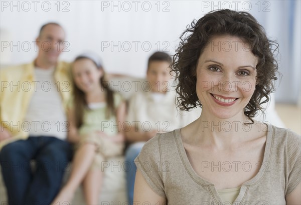 Mother with family in background.