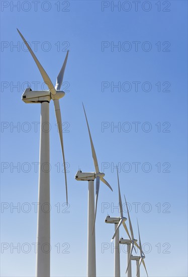 Low angle view of wind turbines.