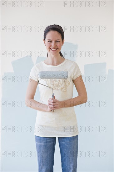 Woman holding paint roller.